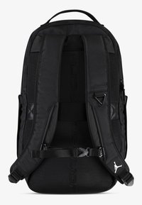Black backpack featuring padded shoulder straps, textured fabric, curved shape, and a prominent logo on the strap. Zippered compartments included.