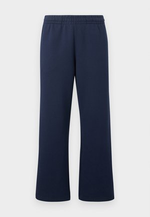 Pantalones de pierna recta con cintura elástica en azul marino y textura suave sobre un fondo claro liso.