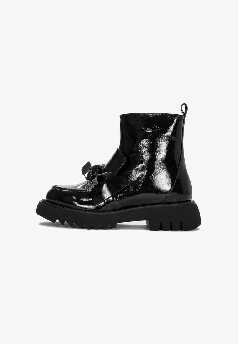 Czarne lakierowane botki za kostkę z masywną podeszwą i detalem w postaci kokardy z przodu, charakteryzujące się eleganckim, błyszczącym wykończeniem oraz pętelką do zakładania.
