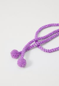 Purple beaded necklace featuring two round, textured clusters at the ends, with strands made of small cylindrical beads.