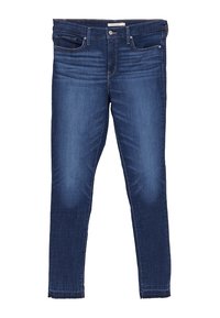 Jeans ajustados en denim azul oscuro, con cintura de altura media, diseño de cinco bolsillos, sutil desvanecimiento en los muslos y dobladillo deshilachado en el tobillo.