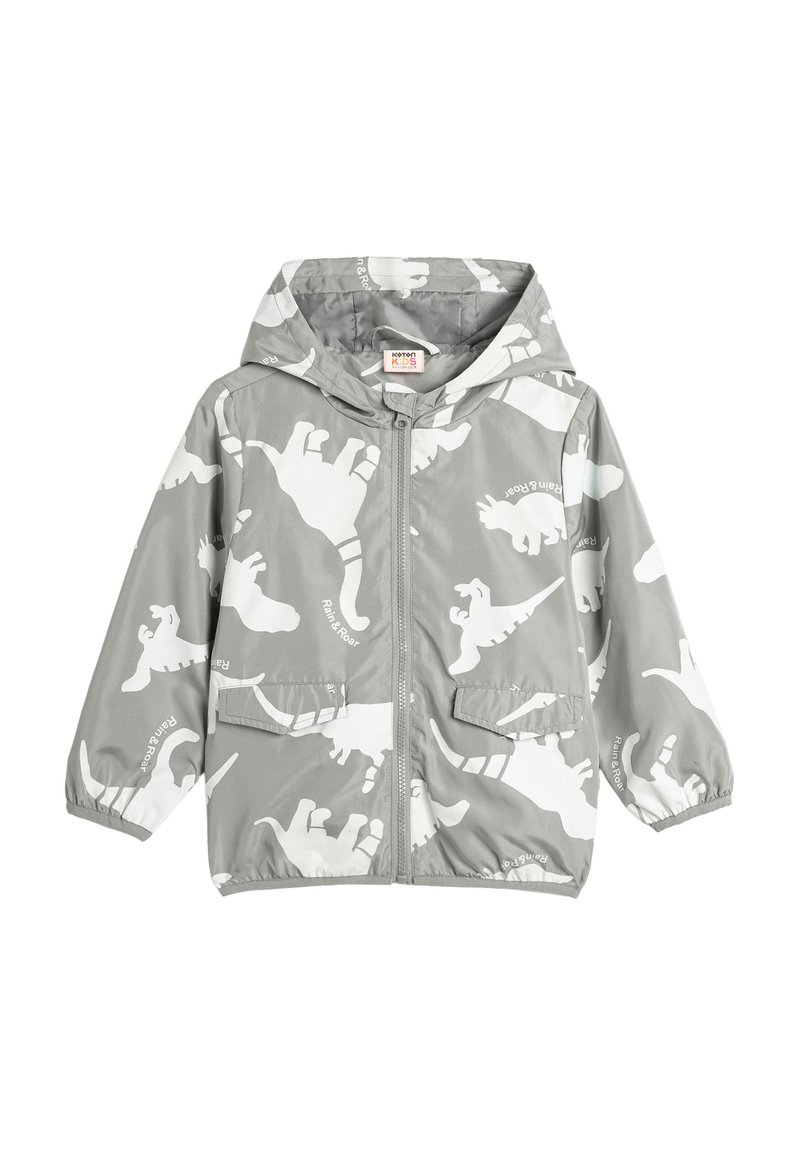 Grijze kinder regenjas met capuchon, voorzien van witte dinosaurussen prints en een ritssluiting aan de voorkant, met elastische manchetten en twee klepzakken.