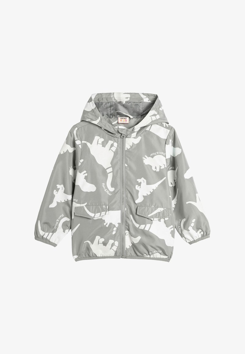 Grijze kinder regenjas met capuchon, voorzien van witte dinosaurussen prints en een ritssluiting aan de voorkant, met elastische manchetten en twee klepzakken.