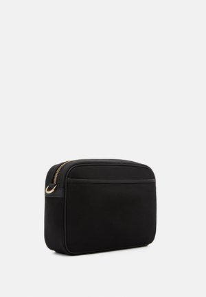 Black rectangular bag made of smooth material, featuring a gold zipper and a flat front pocket. Simple design with no visible patterns.