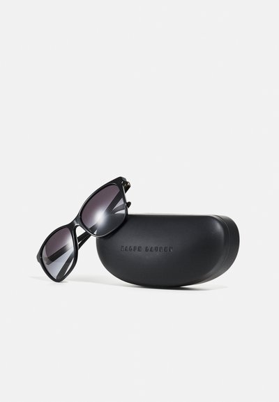 Black sunglasses with gradient lenses, featuring a sleek, angular design. Accompanied by a black hard case with embossed branding.