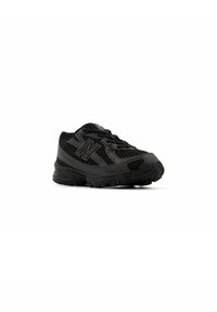 Black athletic shoe with a mesh upper, textured design, sturdy rubber sole, and a prominent logo on the side. Rounded toe and laces.