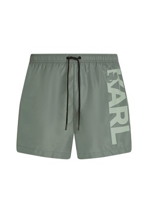 Pantaloncini da bagno grigi con coulisse nera e grande testo "KARL" di colore grigio chiaro stampato verticalmente sulla gamba sinistra.