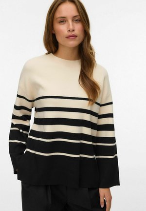 Maglione a righe crema e nero con scollatura rotonda, vestibilità ampia e texture a coste. Presenta ampie righe orizzontali e maniche lunghe.