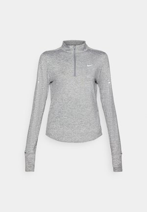 Top sportiv de culoare gri deschis, cu mâneci lungi și guler cu fermoar până la jumătate, având o textură de țesătură respirabilă și un logo mic pe pieptul stâng.