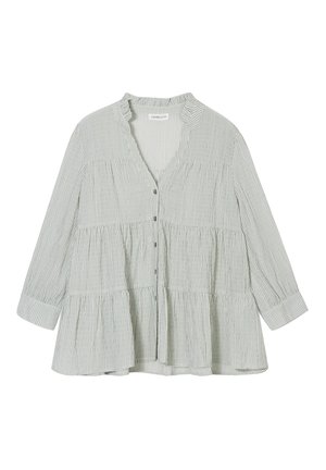 Blouse rayée verte et blanche avec un design peplum, manches longues, décolleté en V, boutons sur le devant et une texture en coton douce.