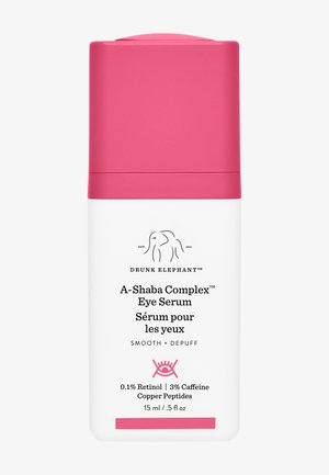 White cylindrical bottle with a pink cap. Features brand logo and product name in black text. Contains 15 ml of eye serum with key ingredients listed.