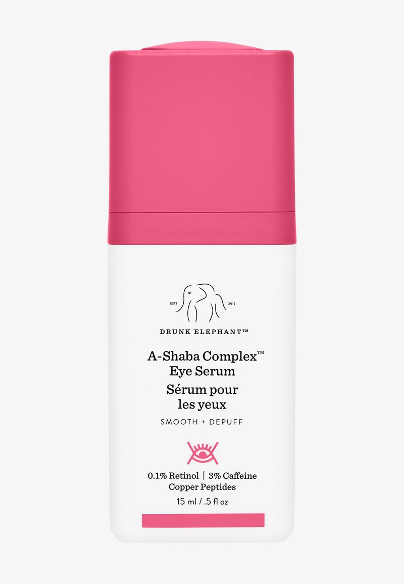 White cylindrical bottle with a pink cap. Features brand logo and product name in black text. Contains 15 ml of eye serum with key ingredients listed.