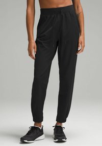 Black athletic pants with a drawstring waist, tapered fit, and elastic cuffs. Made of lightweight material, suitable for active wear.