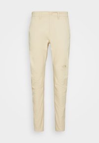 Beige Hose mit geradem Schnitt, aus strapazierfähigem Baumwollstoff. Mit einem Logo am linken Oberschenkel und normalen Front- und Gesäßtaschen.