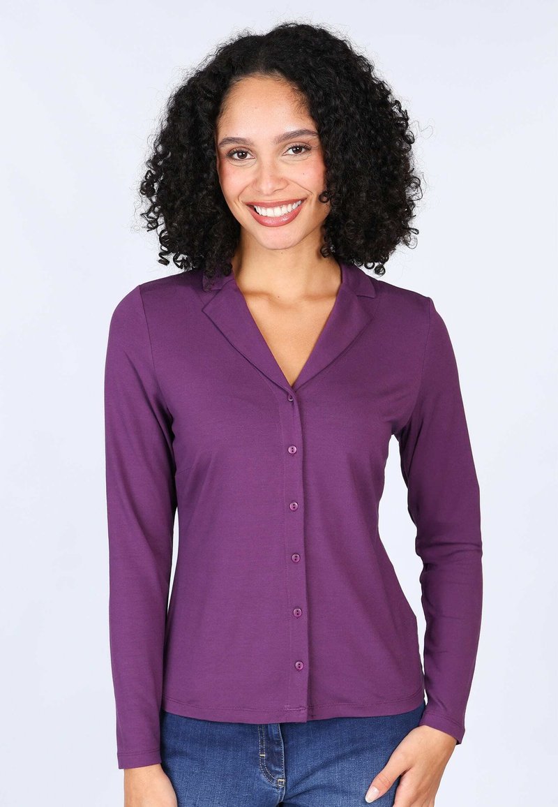 Purple long-sleeve button-up shirt with a shawl collar, made from soft fabric, featuring a front placket with matching buttons and a fitted shape.
