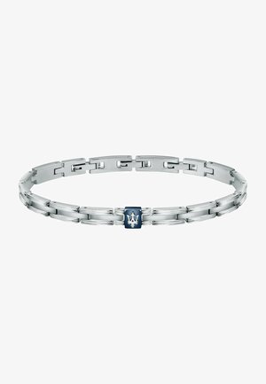 Sølv metalarmbånd med sammenkoblede led, en glat overflade og en blå rektangulær accent med et hvidt emblem i centrum.