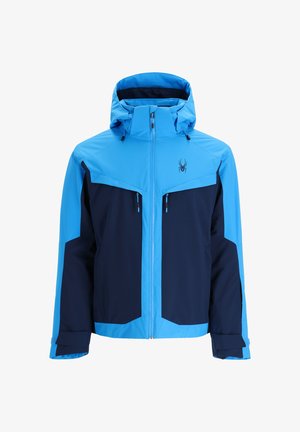 Giacca impermeabile blu e navy con cappuccio, dotata di tasche con zip, polsini regolabili e un logo sul petto.