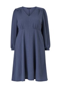 Robe bleu marine à manches longues avec un décolleté en V, en tissu texturé, taille cintrée et jupe évasée qui tombe sous le genou.