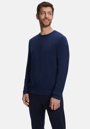 Navy blue knitted crew neck sweater with long sleeves and ribbed cuffs, featuring a textured pattern and a solid hem.
