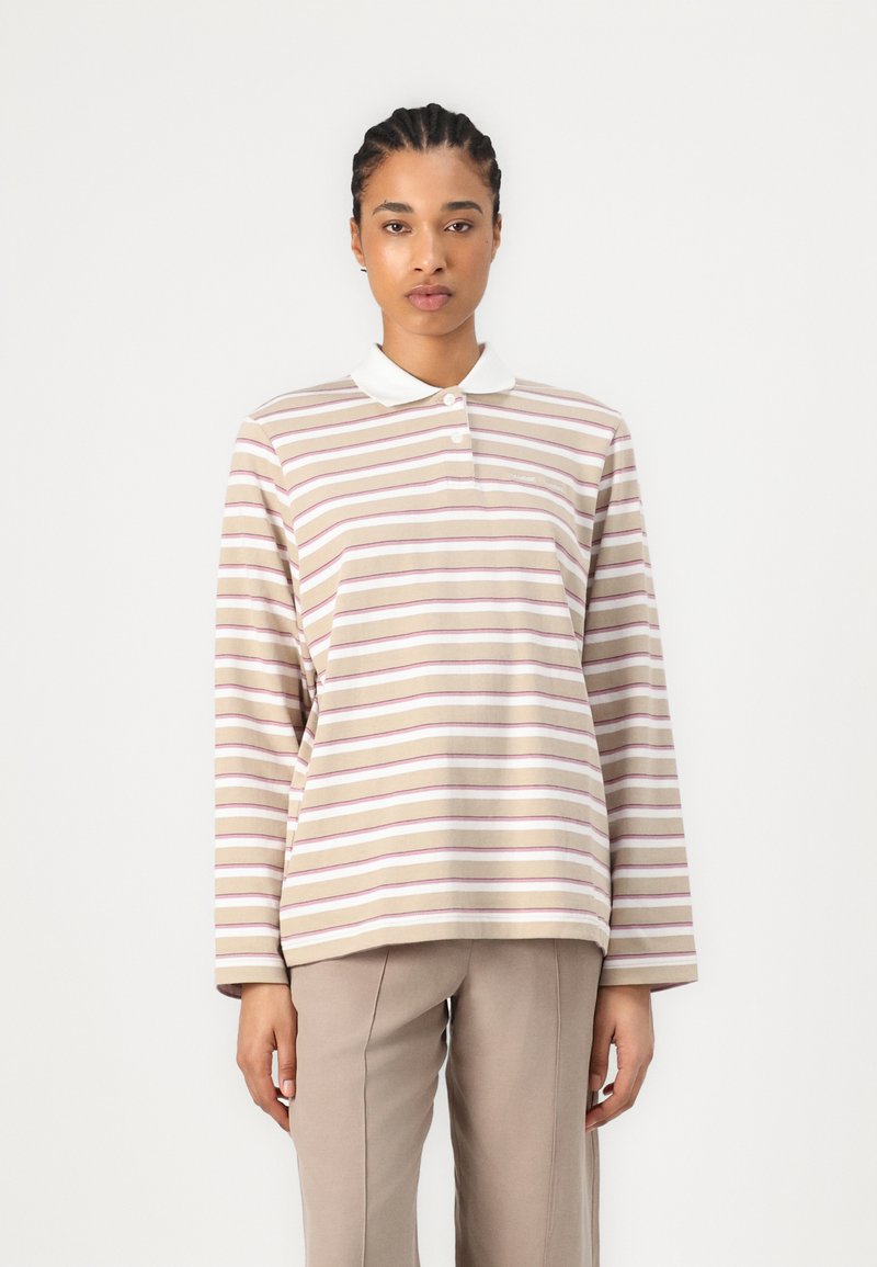 Striped long-sleeve polo shirt in beige, featuring purple and white lines, with a white collar and button detail, made from a soft fabric.