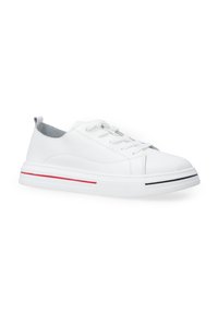 Weißer Leder-Sneaker mit niedrigem Profil, runder Zehenform und kontrastierenden roten und schwarzen Akzenten an der Sohle. Flache Schnürsenkel und eine Schlaufe an der Ferse.