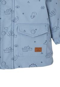 Helles Blaues Kinderjacke mit Dinosaurierdruck, Druckknöpfen, Fronttasche mit Klappe und dem Patch "Erkunde die Welt".