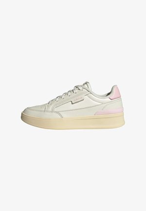 Light grey athletic shoe with a smooth leather upper, textured accents in pink, and a chunky beige rubber sole. Features flat laces and perforations.