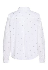 Chemise blanche à manches longues ornée d'un petit motif noir répété. Col boutonnière et poignets à boutons avec une coupe décontractée et une texture lisse.