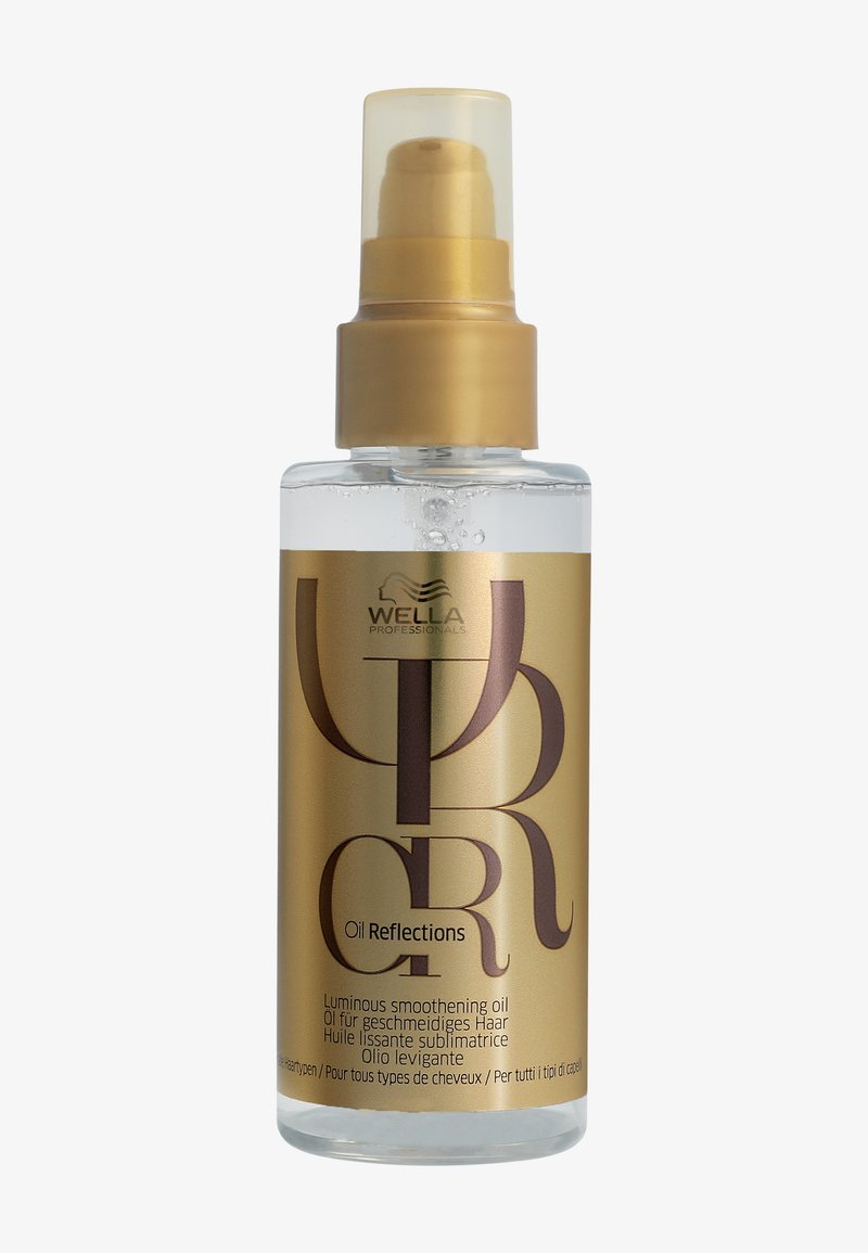 Flacon transparent d'huile lissante lumineuse Wella Professionals Oil Reflections avec pompe et étiquette dorées, adaptée à tous les types de cheveux.