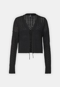 Černý krátký kardigan vyrobený z pletené látky. Má výstřih do V, dlouhé rukávy a zavírání na zavazování v přední části s otevřeným vzorem.