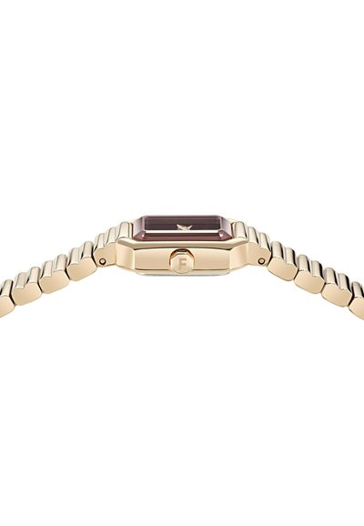 Arany tónusú karóra nyolcszögletű tokkal, lila üveggel és rugalmas, szegmenses szíjjal. A koronán "F" betűs log�ó található.