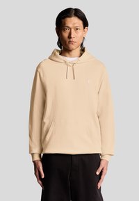 Beige Kapuzenpullover aus weichem Stoff, mit einer Kängurutasche, verstellbarem Kordelzug mit Kapuze und einem kleinen gestickten Logo auf der Brust.