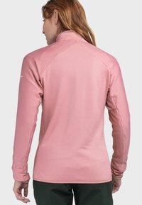 Langärmlige, Reißverschluss-Jacke in Hellrosa, mit einem strukturierten Rippmuster. Entworfen mit einem hohen Kragen und schmalen Ärmel für einen eleganten Look.