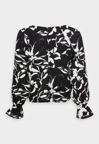 Blouse noire avec un motif floral blanc, manches longues bouffantes avec poignets élastiques et encolure ronde. Tissu léger avec une texture lisse.