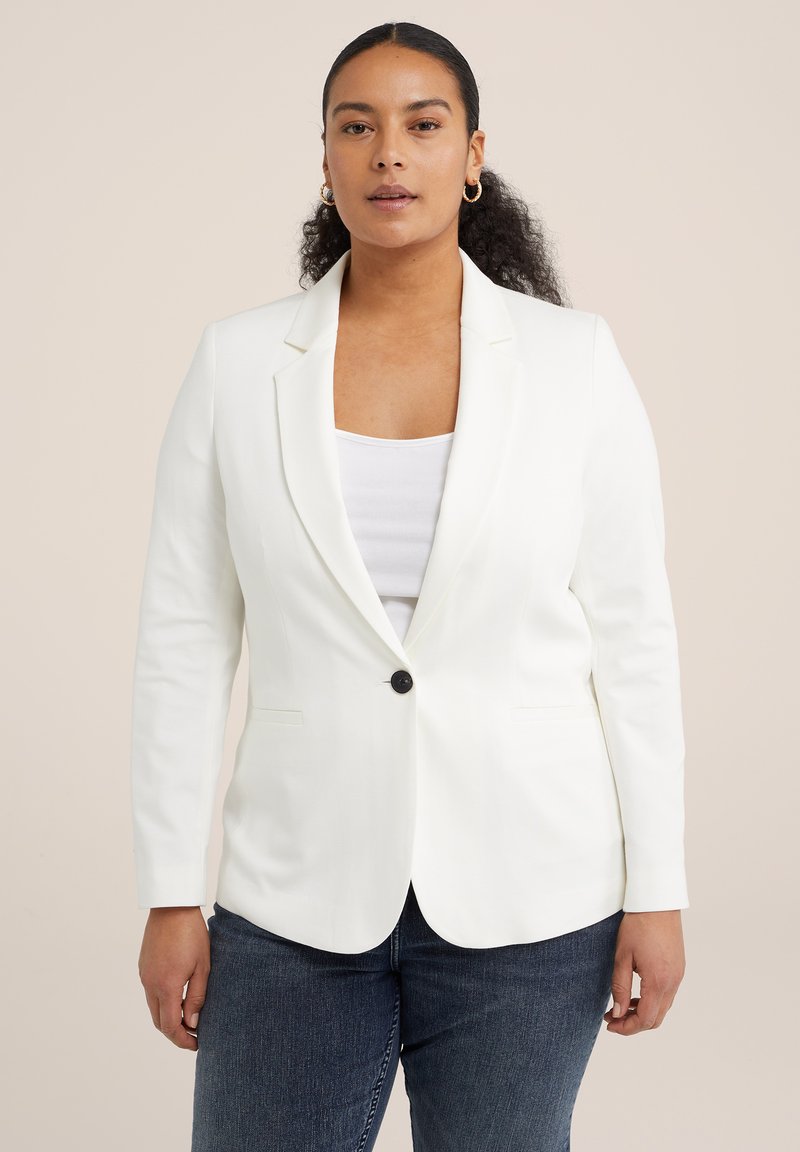 Blazer alb cu rever tăiat, închidere cu un singur buton și două buzunare frontale. Stylistat cu un maiou basic și blugi închiși la culoare.