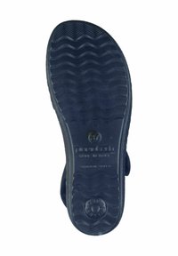Mørkeblå gummisål med bølgemønster, prydet med et cirkulært logoaftryk og forhøjede detaljer langs kanterne. Fremstillet i Italien.