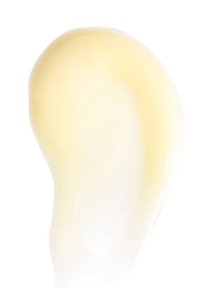 Krämlig beige kosmetik- eller hudvårdsprodukt med slät konsistens på en vit bakgrund.