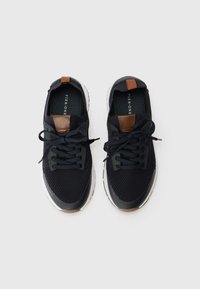 Black mesh sneakers with brown leather accents, round toe, rubber sole, and lace-up design. Textured surface and light cushioning.