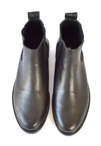 Schwarze Leder-Ankle-Boots mit elastischen Seitenpaneelen, abgerundeter Zehenpartie, glatter Textur und Zuglasche hinten. Die Sohle ist strukturiert.