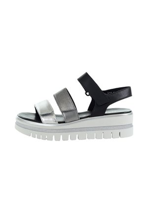 Women's platform sandal with three adjustable straps in silver and black, and a thick white rubber sole with deep treads.