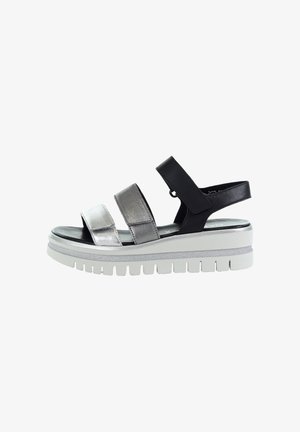 Women's platform sandal with three adjustable straps in silver and black, and a thick white rubber sole with deep treads.