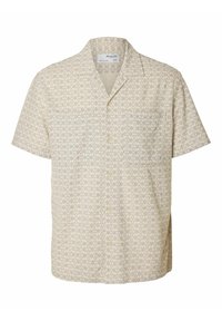 Kortegeren knoopshirt in lichtbeige met een bloemenpatroon. Bevat een kraag, een borstzak en heeft een ontspannen pasvorm.