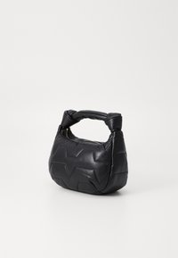 Black leather handbag with a knotted handle, featuring a quilted texture and zigzag pattern on the body. Zipper closure at the top.