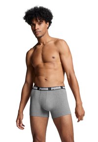 Gray boxer briefs made of cotton with a black elastic waistband featuring the Puma logo. Fitted design with a smooth texture.