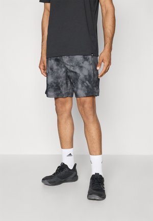 Gray tie-dye athletic shorts with an elastic waistband, paired with black sneakers and white ankle socks. T-shirt is solid black.