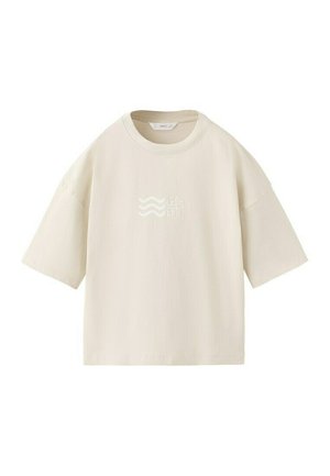 Bielo-krémové oversized tričko s krátkym rukávom a okrúhlym výstrihom, s jemným nápisom „LEGEND“ a vlnkovými čiarami v strede prednej časti.