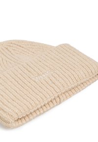 Beanie a costine beige ripiegato al polsino con il logo Vans ricamato in modo discreto sul davanti.