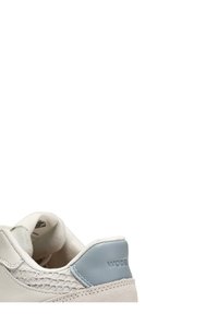 Back view of a white sneaker with light blue leather heel tab and textured side panel detailing.