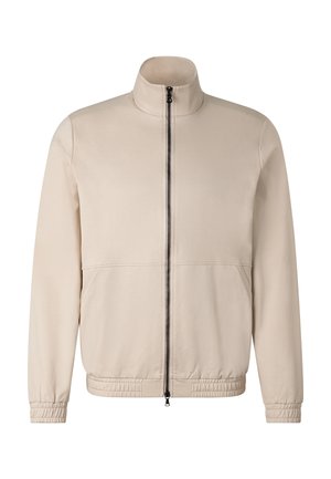 Beige Zip-Up-Jacke mit Stehkragen, langen Ärmeln, elastischen Bündchen und Saum, vorderen Nähten und einem schwarzen zentralen Reißverschluss.