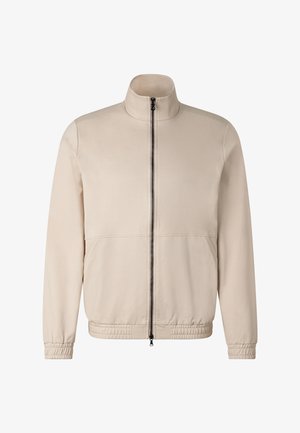 Beige Zip-Up-Jacke mit Stehkragen, langen Ärmeln, elastischen Bündchen und Saum, vorderen Nähten und einem schwarzen zentralen Reißverschluss.